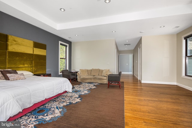 bedroom featuring wood finished floors, recessed lighting, and baseboards