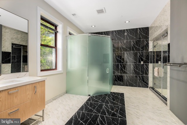 full bathroom with recessed lighting, marble tiled flooring, a stall shower, and vanity