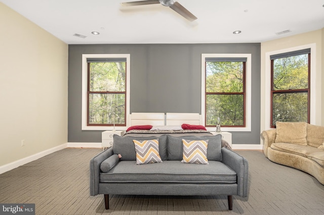 living area with baseboards, recessed lighting, plenty of natural light, and a ceiling fan