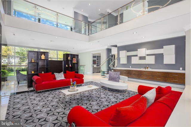 living area with a high ceiling, recessed lighting, and stairs