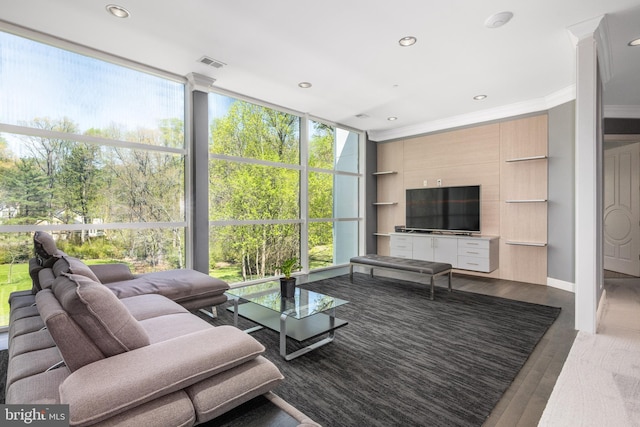 living area with crown molding, wood finished floors, recessed lighting, and baseboards