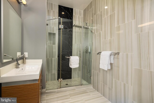 bathroom with a stall shower and vanity