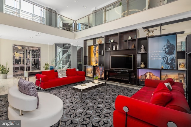living room featuring a towering ceiling and recessed lighting