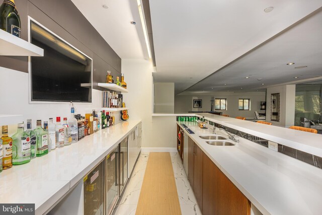 indoor bar with baseboards, light marble finish flooring, and recessed lighting