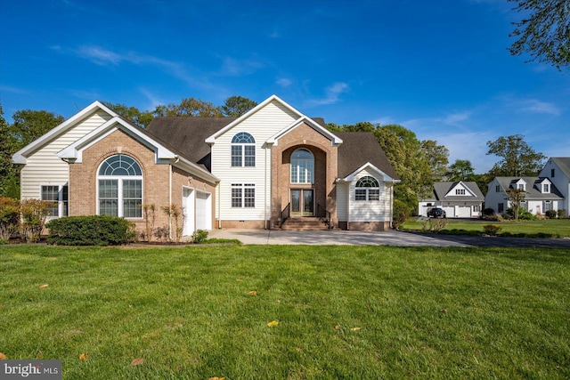 traditional home with concrete driveway, brick siding, an attached garage, and a front yard