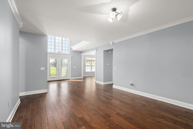 unfurnished living room featuring crown molding, baseboards, and dark wood-style floors