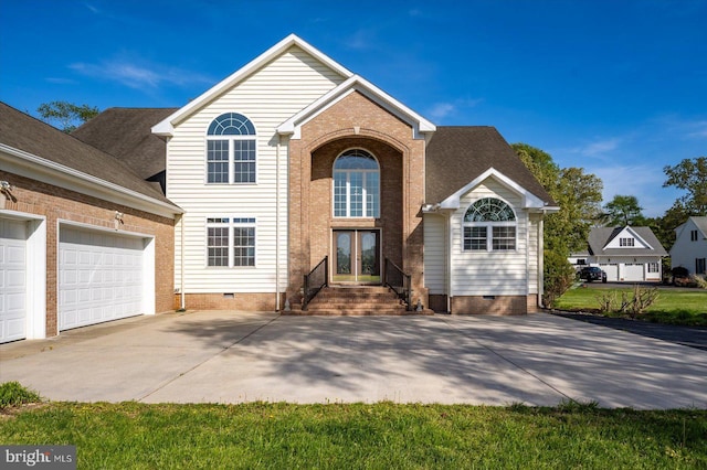 traditional-style home featuring a garage, french doors, brick siding, crawl space, and concrete driveway