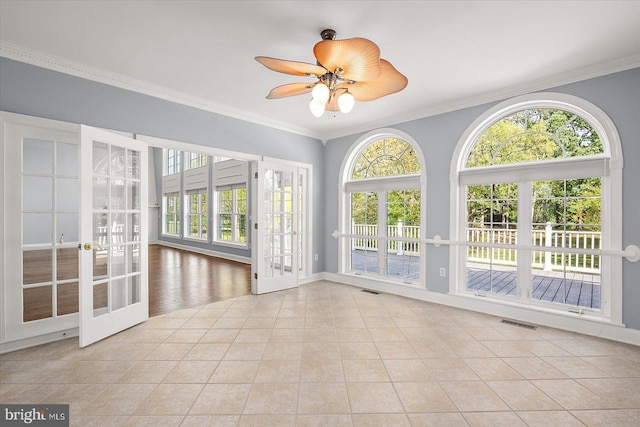 unfurnished sunroom with french doors, visible vents, and a wealth of natural light