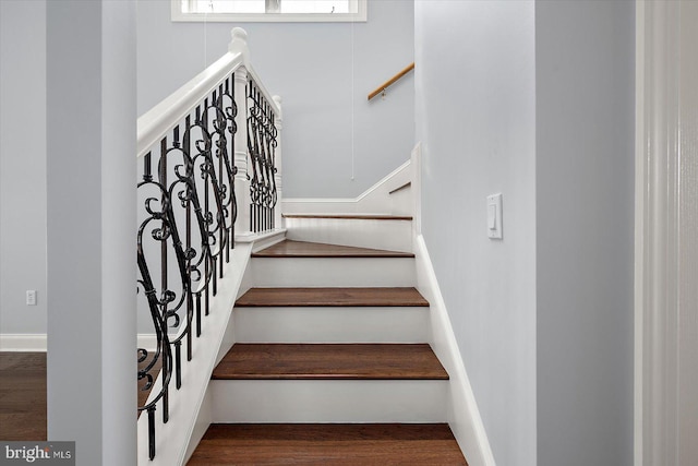 stairs featuring wood finished floors