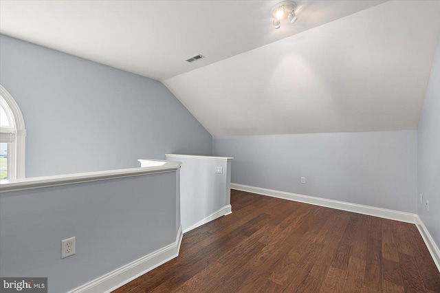 bonus room featuring visible vents, baseboards, lofted ceiling, and wood finished floors