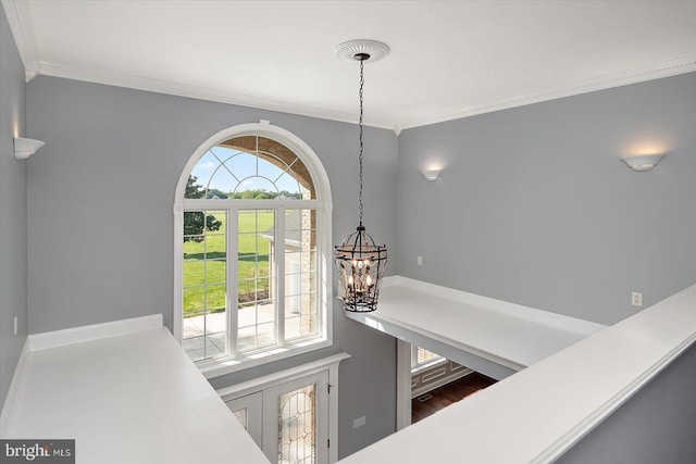 details with an inviting chandelier and ornamental molding