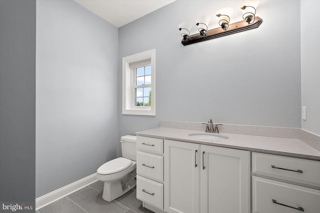 half bath featuring vanity, baseboards, and toilet