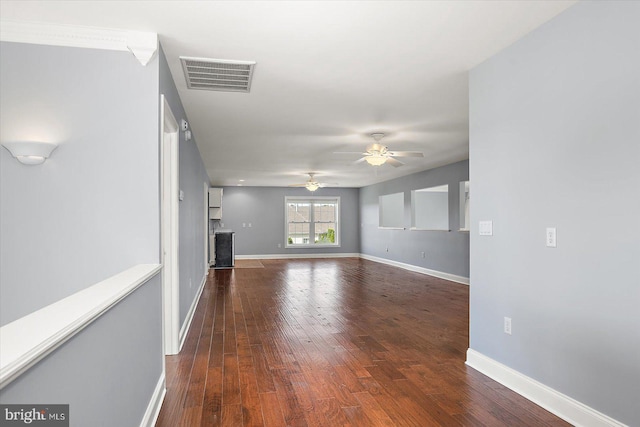 unfurnished living room with baseboards, ceiling fan, hardwood / wood-style flooring, and visible vents