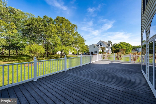 wooden terrace with a yard and a residential view