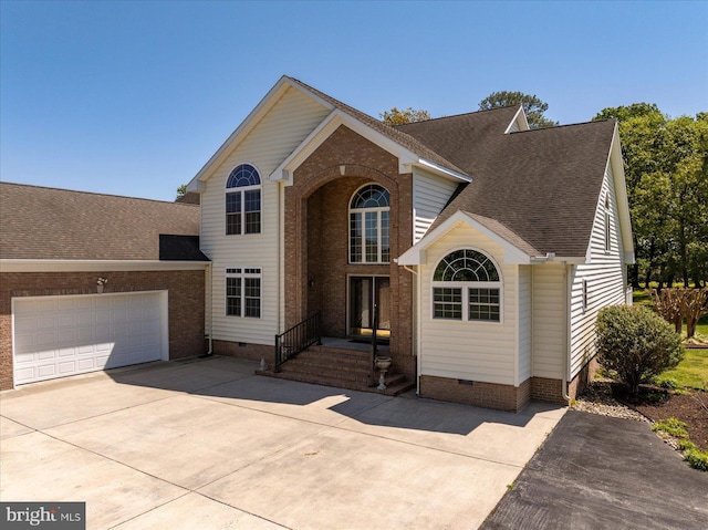 traditional-style home with a garage, a shingled roof, driveway, and crawl space