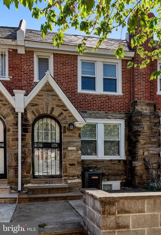 doorway to property with brick siding