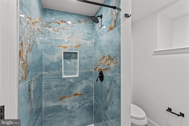 full bathroom with a marble finish shower and toilet