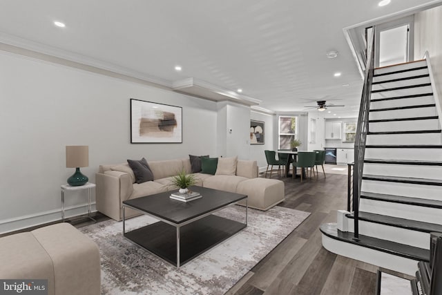 living area featuring ceiling fan, crown molding, stairs, wood finished floors, and recessed lighting