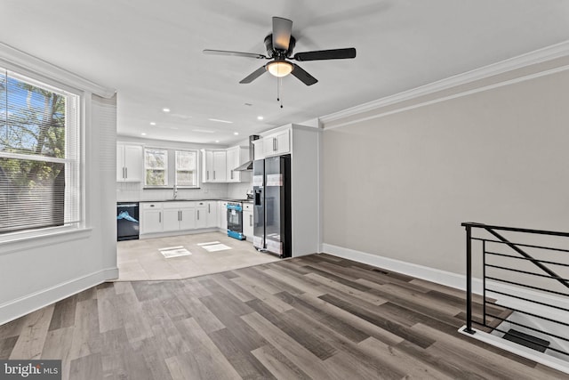 unfurnished living room with ceiling fan, light wood-type flooring, a sink, baseboards, and recessed lighting