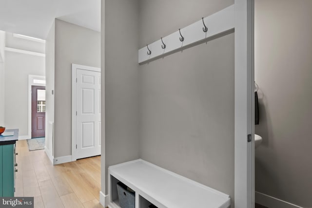 mudroom featuring baseboards and light wood finished floors