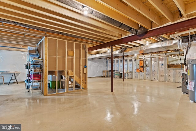 unfinished basement featuring electric water heater