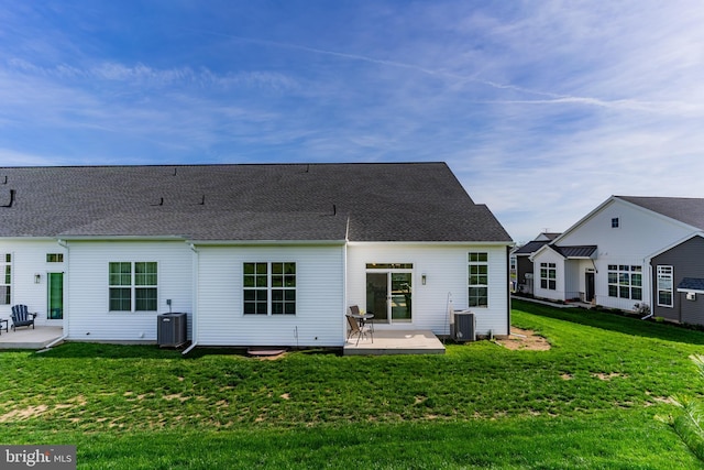 rear view of property with a patio, a yard, and central AC unit