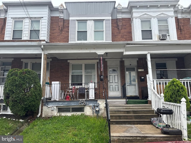 1107 E 11th St, Crum Lynne, PA 19022 - view of property featuring brick siding, a porch, and cooling unit