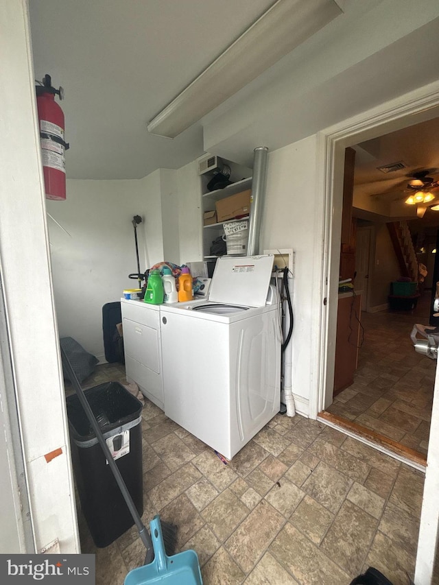 1107 E 11th St, Crum Lynne, PA 19022 - clothes washing area featuring washing machine and dryer, stone finish flooring, and a ceiling fan