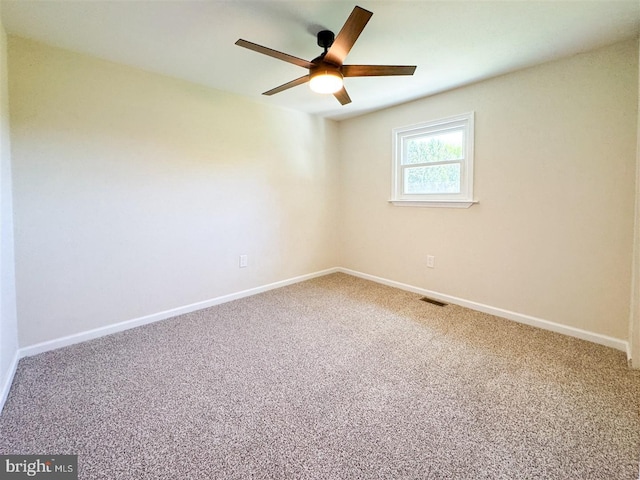 unfurnished room featuring ceiling fan, visible vents, baseboards, and carpet