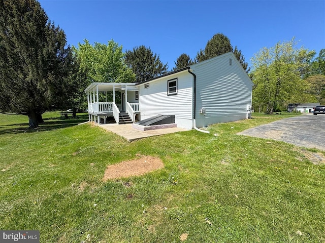 back of property with a yard and a sunroom