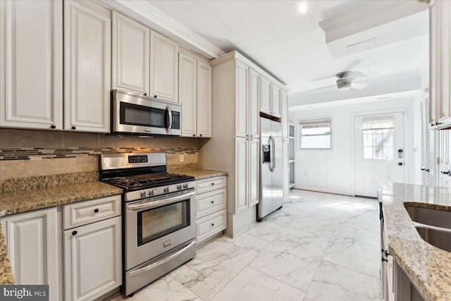 kitchen featuring stainless steel appliances, tasteful backsplash, light marble finish floors, crown molding, and ceiling fan