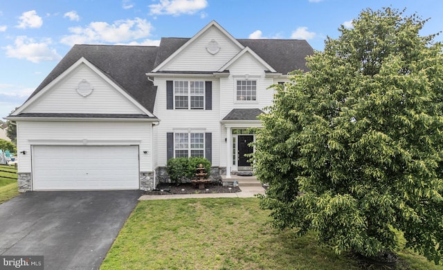 54 Durham Ln, Smyrna, DE 19977 - traditional-style home with driveway, stone siding, a garage, a front yard, and a shingled roof