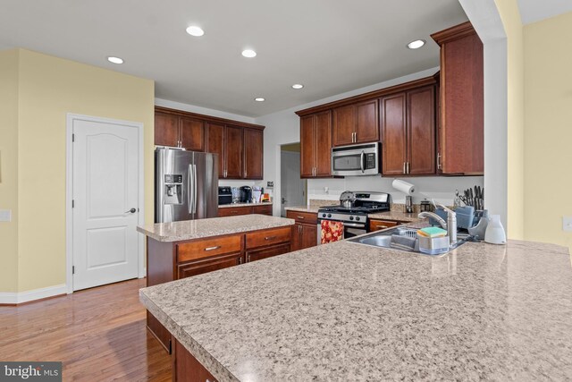 54 Durham Ln, Smyrna, DE 19977 - kitchen with stainless steel appliances, a sink, light wood finished floors, recessed lighting, and a center island