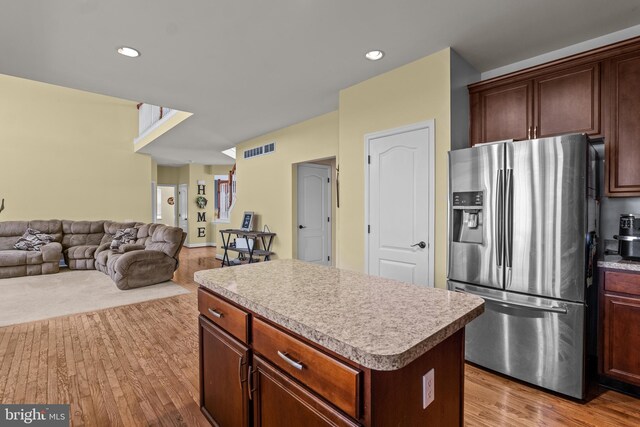 54 Durham Ln, Smyrna, DE 19977 - kitchen with stainless steel fridge with ice dispenser, a kitchen island, wood finished floors, light countertops, and open floor plan