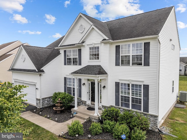 54 Durham Ln, Smyrna, DE 19977 - traditional home with stone siding, a garage, roof with shingles, and central air condition unit