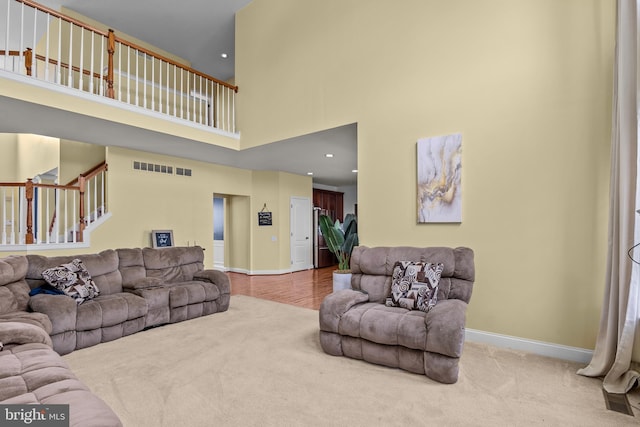 54 Durham Ln, Smyrna, DE 19977 - living room featuring a high ceiling, baseboards, carpet flooring, stairway, and recessed lighting