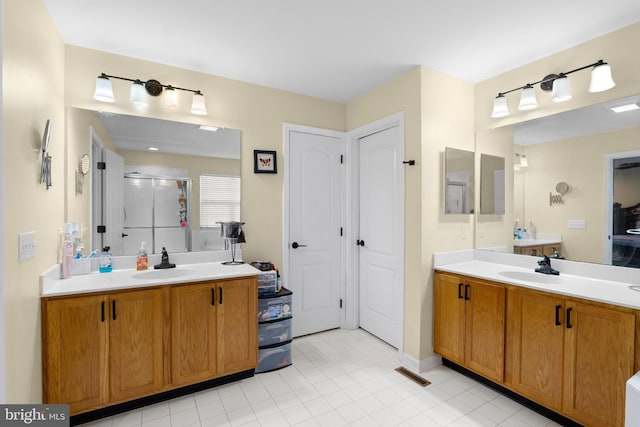 54 Durham Ln, Smyrna, DE 19977 - bathroom with a stall shower, two vanities, and tile patterned flooring