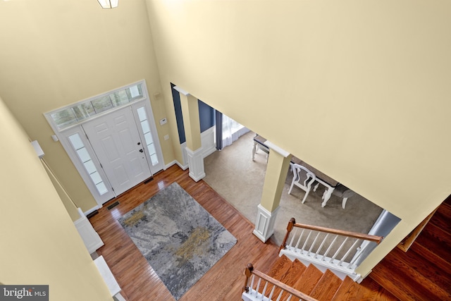 54 Durham Ln, Smyrna, DE 19977 - entryway featuring stairway, wood finished floors, healthy amount of natural light, a towering ceiling, and baseboards