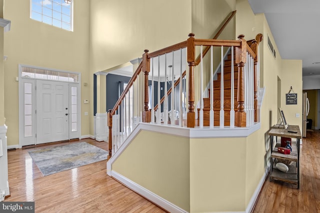 54 Durham Ln, Smyrna, DE 19977 - entrance foyer with wood finished floors, a towering ceiling, stairs, and baseboards