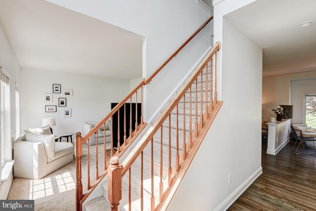 stairway featuring baseboards and wood finished floors