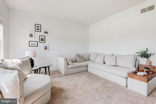 living room featuring visible vents and carpet flooring