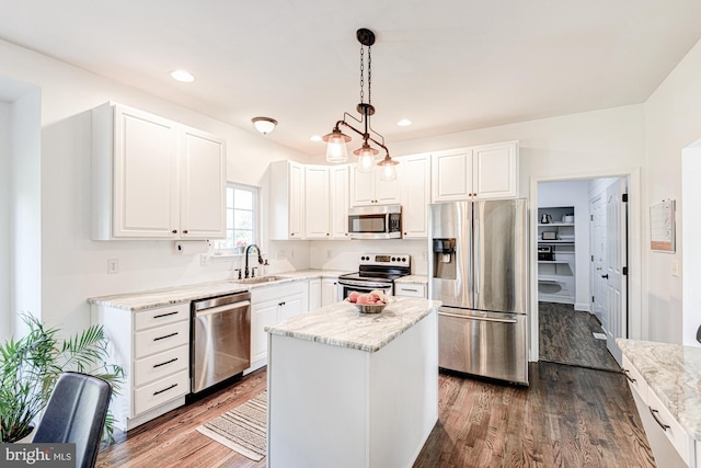 kitchen featuring a sink, white cabinetry, wood finished floors, and stainless steel appliances