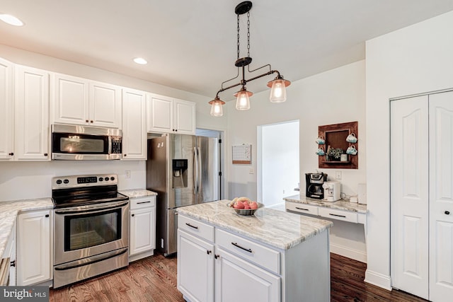 kitchen with dark wood-style flooring, pendant lighting, a center island, stainless steel appliances, and white cabinetry