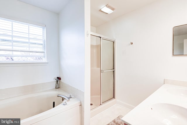 full bath with double vanity, a shower stall, a sink, and a bath