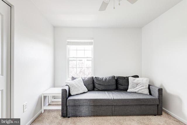 sitting room with baseboards, ceiling fan, and carpet flooring
