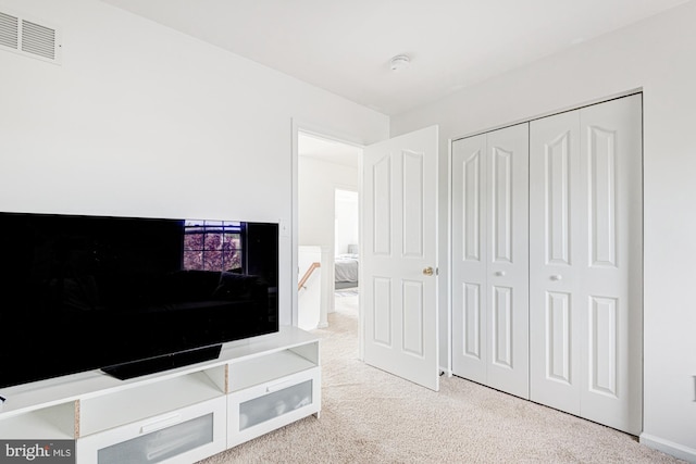 interior space with visible vents and light carpet