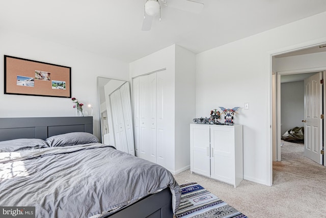 bedroom with baseboards, ceiling fan, and light carpet