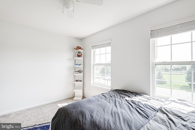 bedroom with baseboards, a ceiling fan, and carpet