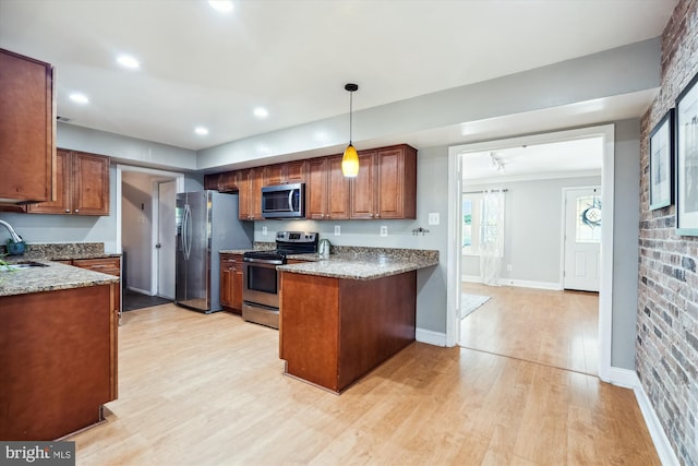 13446 Overbrook Ln, Bowie, MD 20715 - kitchen with appliances with stainless steel finishes, a peninsula, a sink, light wood-style flooring, and brown cabinets