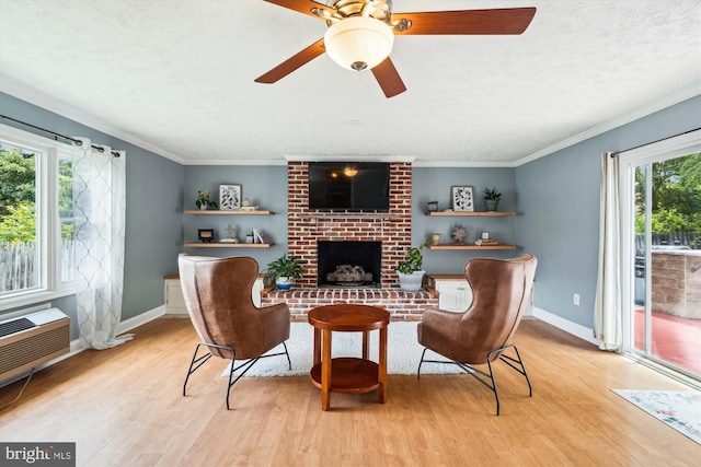 13446 Overbrook Ln, Bowie, MD 20715 - living area with light wood-type flooring, a fireplace, ceiling fan, a textured ceiling, and baseboards